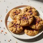 Close-up of chewy Halloween sprinkle cookies with orange, purple, and black sprinkles.