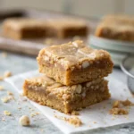 Close-up of stacked maple pecan cookie bars showing chewy interior and glaze.
