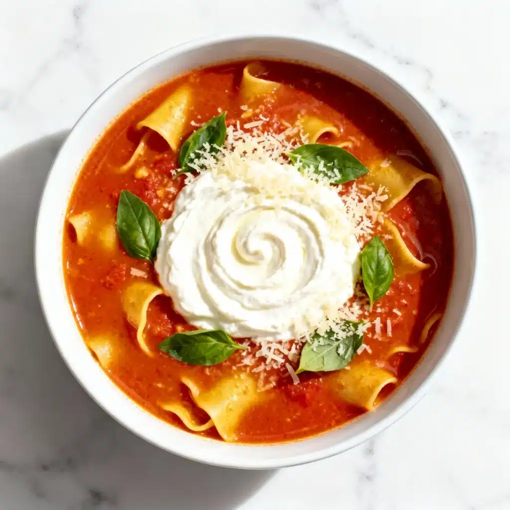 Bowl of High Protein Creamy Lasagna Soup with cottage cheese swirl, parmesan, and basil