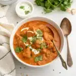 A fresh, vibrant bowl of homemade Slow Cooker Butter Chicken with extra sauce.