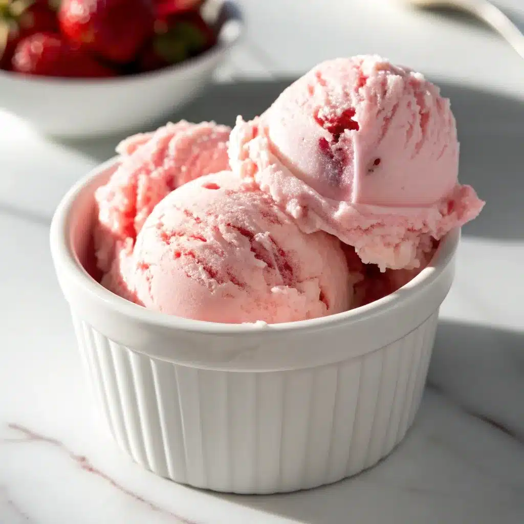 Close up of a scoop of melting strawberry Cottage Cheese Ice Cream.