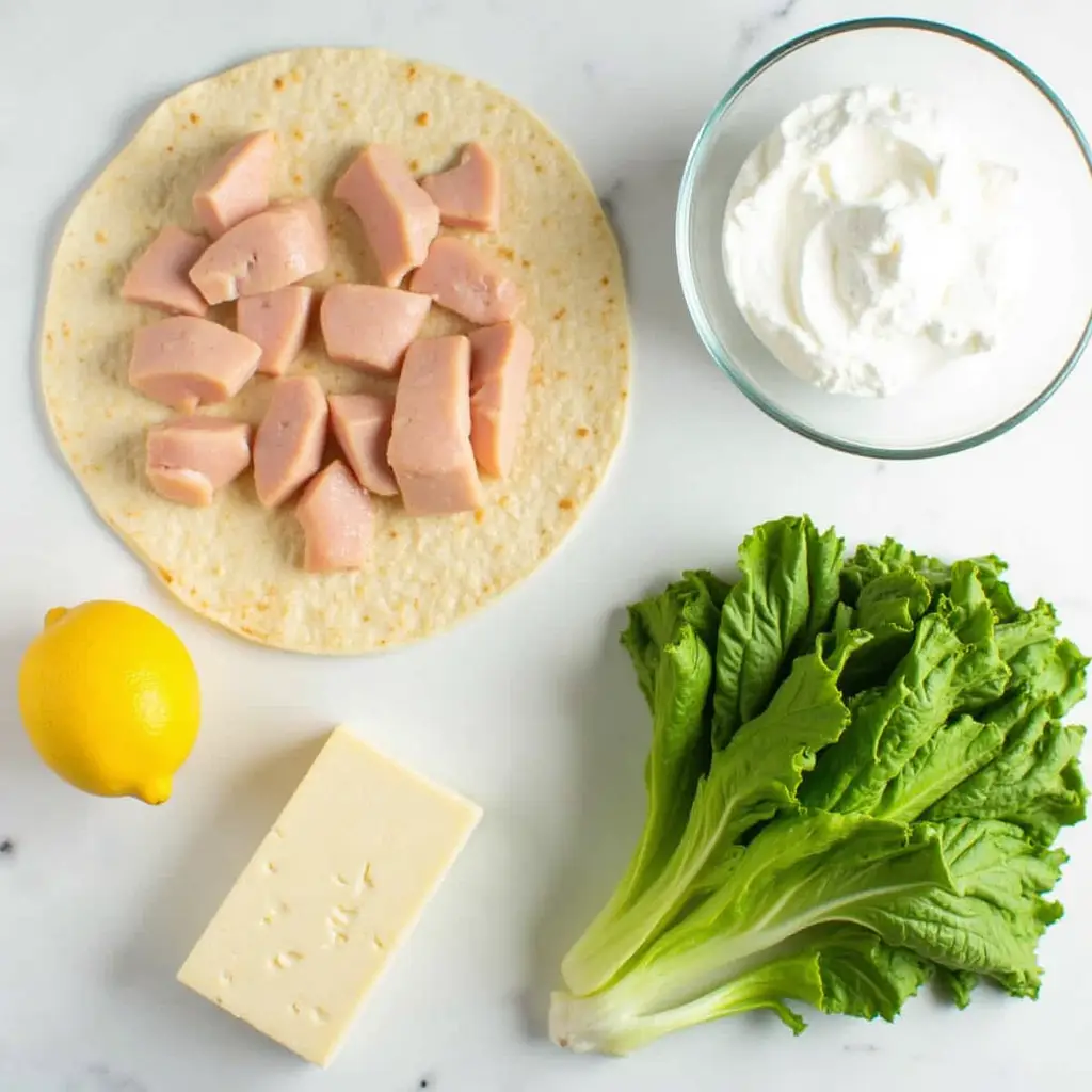 Fresh ingredients for high protein chicken caesar wraps meal prep.