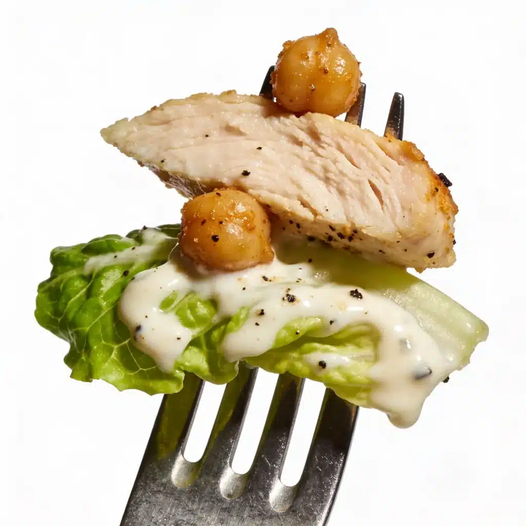 Close up of a fork with chicken, chickpea, and creamy caesar dressing.