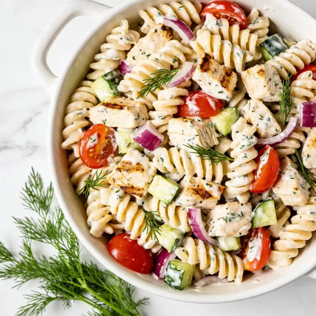 Creamy high protein pasta salad with chicken and veggies in a white bowl.