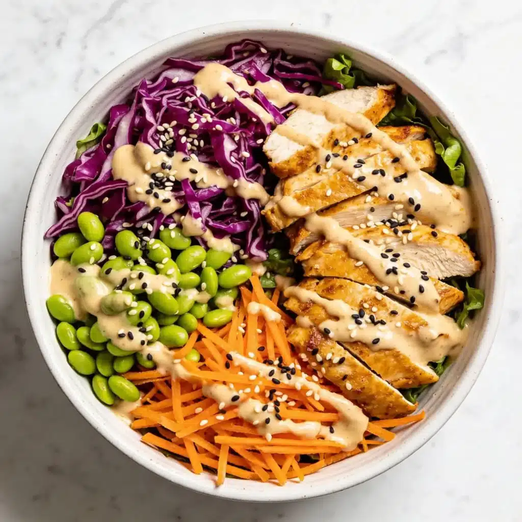 High protein sesame ginger chicken salad with purple cabbage and edamame.