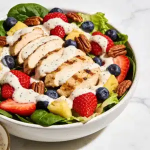 High Protein Strawberry Poppyseed Salad with chicken and poppyseed dressing.