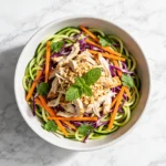 A colorful Vietnamese Chicken Zoodle Salad with shredded chicken and fresh herbs.