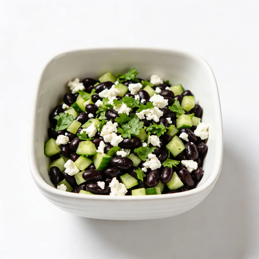 Mediterranean style black bean salad with feta and parsley.