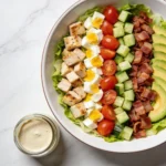 Protein Packed Cobb Salad with ingredients arranged in neat rows.