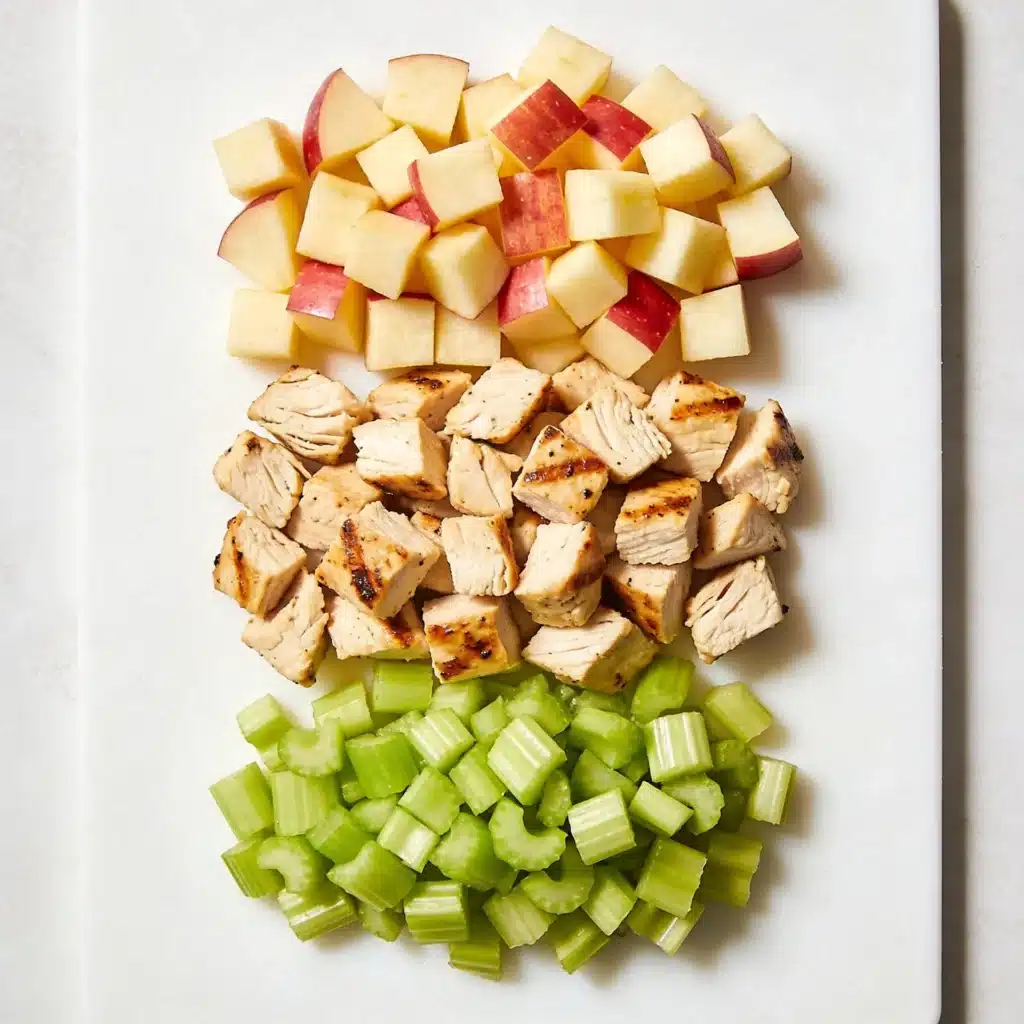 Diced chicken and apples illustrating the uniform dice technique for a professional salad.