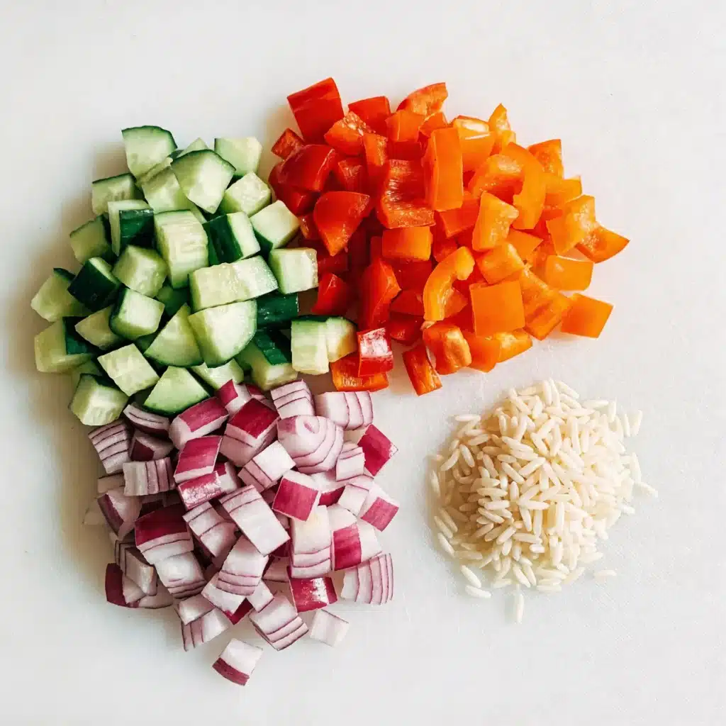 Finely diced cucumbers and peppers matching the size of orzo pasta.