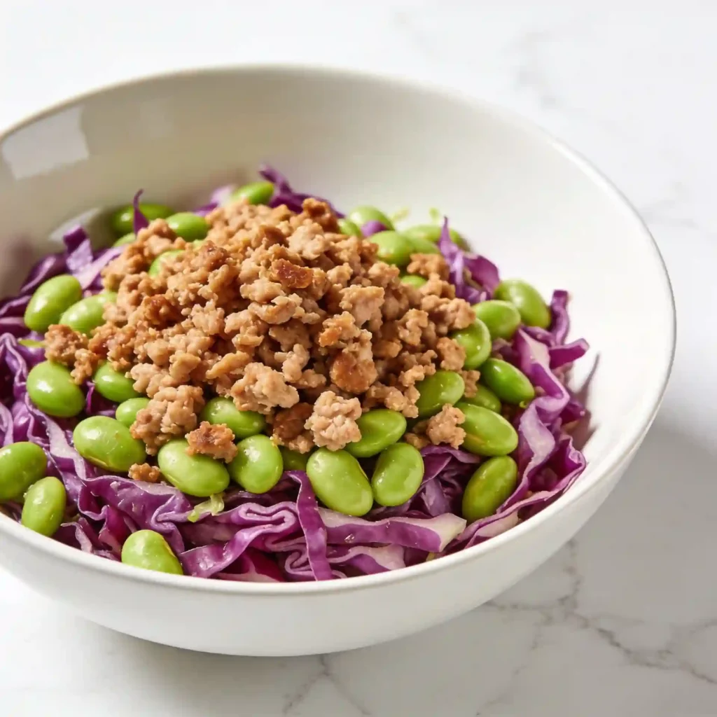 A vibrant Asian edamame crunch salad topped with savory browned ground turkey.