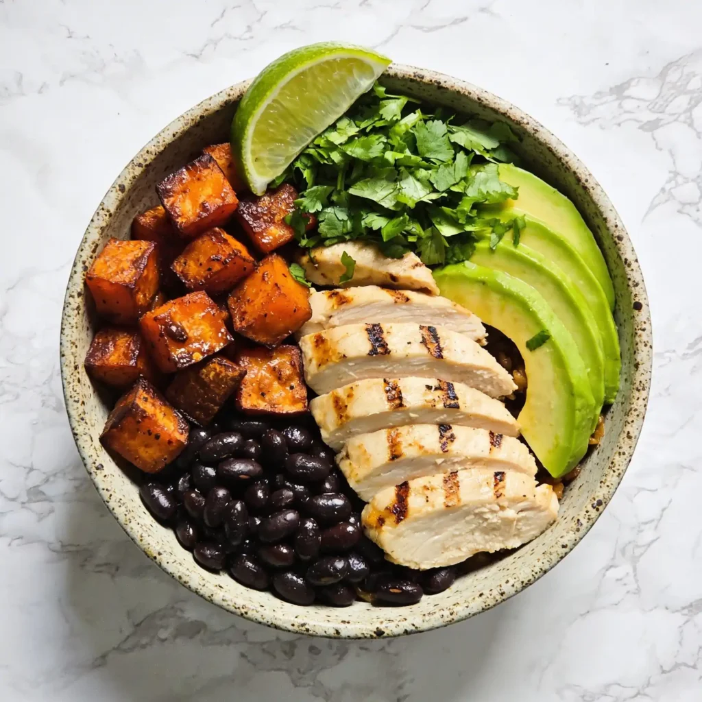 A final plated presentation of the healthy roasted sweet potato black bean bowl.