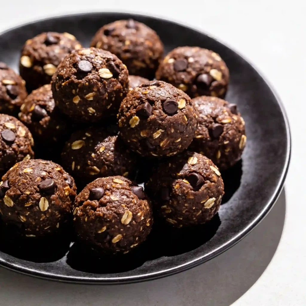 A gorgeous, fully plated serving dish overflowing with fudgy Double Chocolate Energy Bites ready for snacking.
