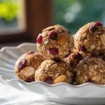 A sophisticated large white plate with cranberry energy balls showing their texture.