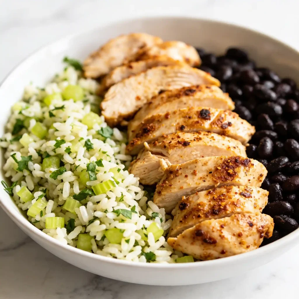 A close up of a high protein chicken burrito bowl showing perfectly cooked rice and seasoned chicken.